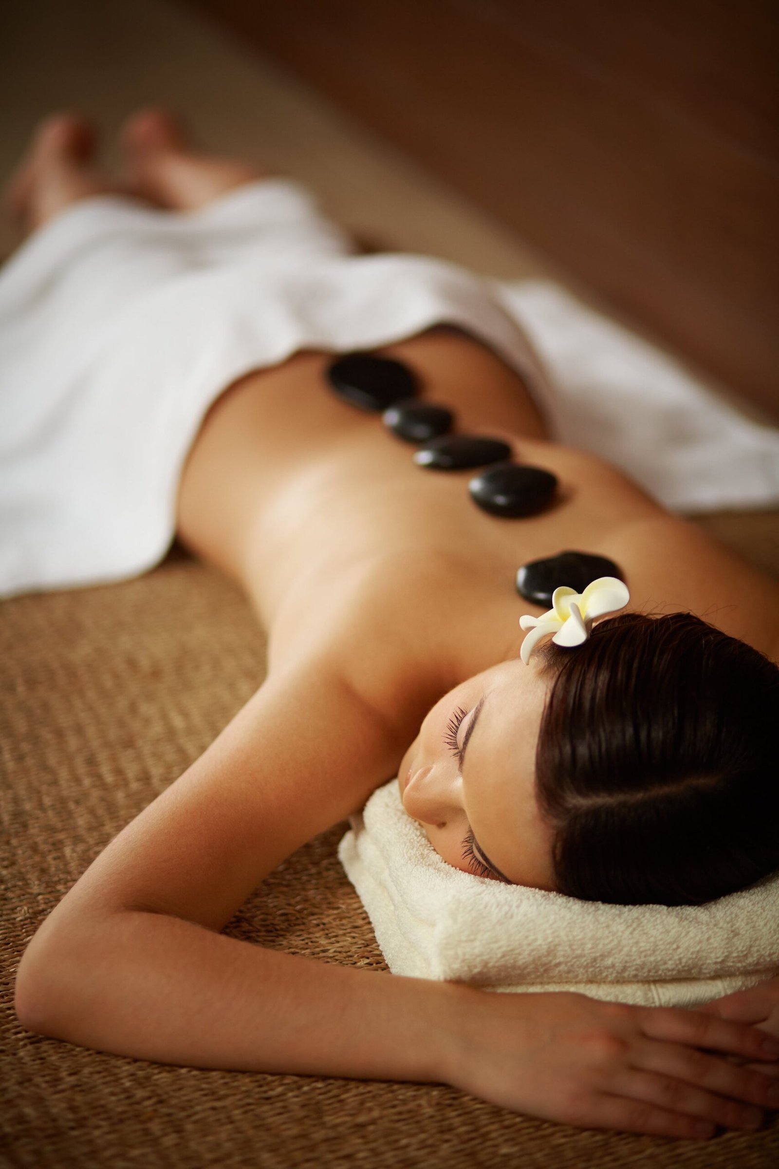 young-woman-with-spa-stones-her-back-min